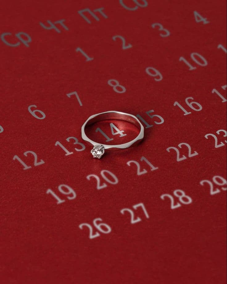 Anillo de compromiso sobre el día 14 de un calendario rojo